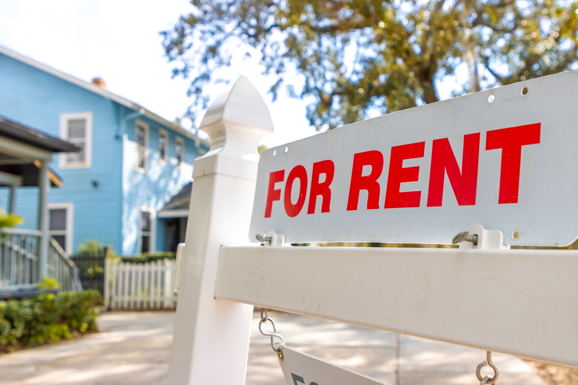 A house for rent sign advertised on a residential property