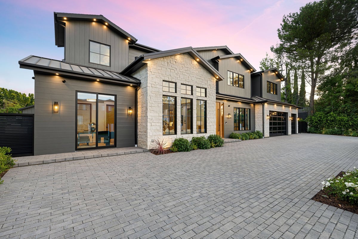Modern residential rental investment property with stone facade and landscaped driveway