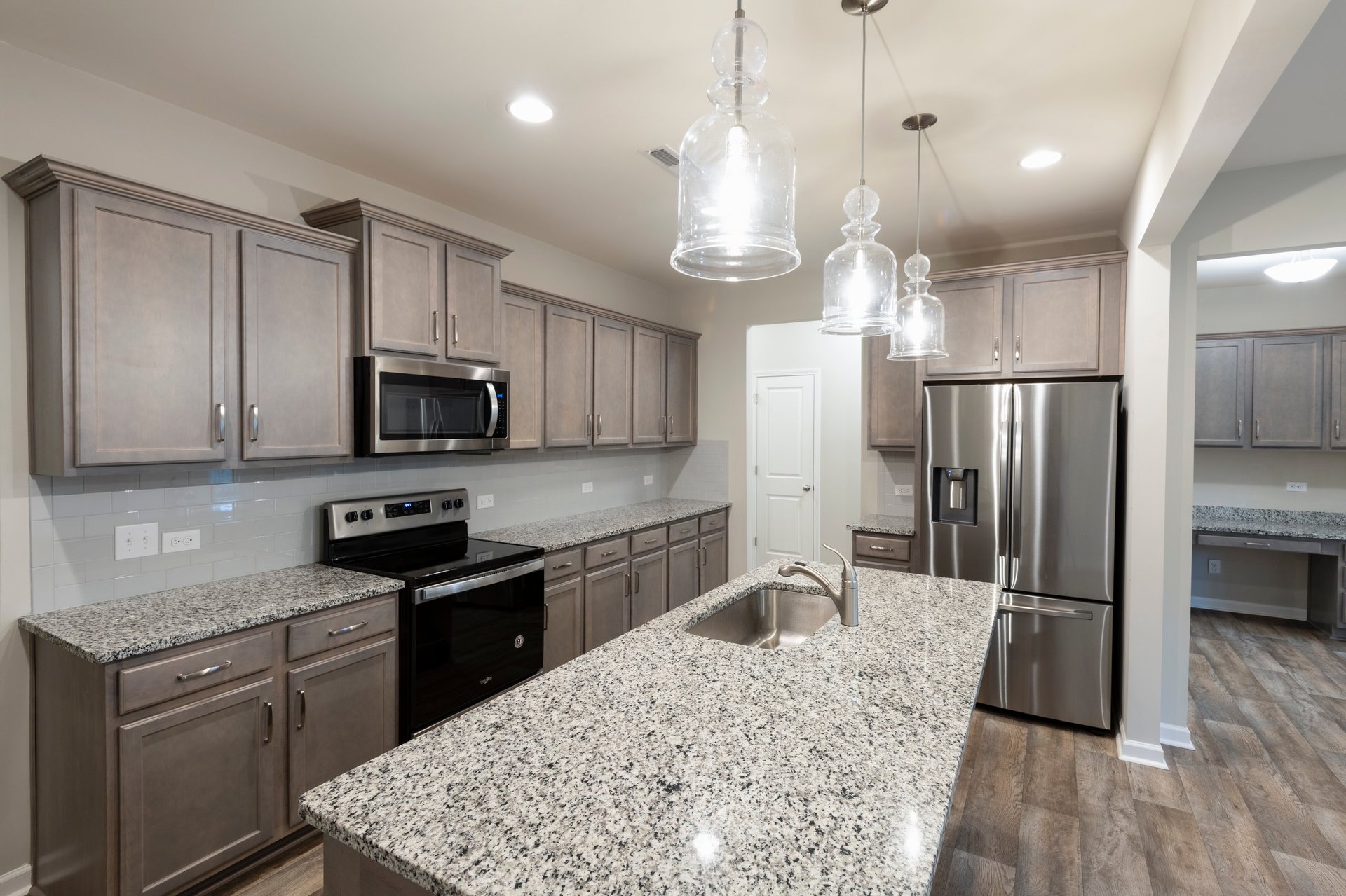 Parent and young adult reviewing purchase figures at a modern kitchen island