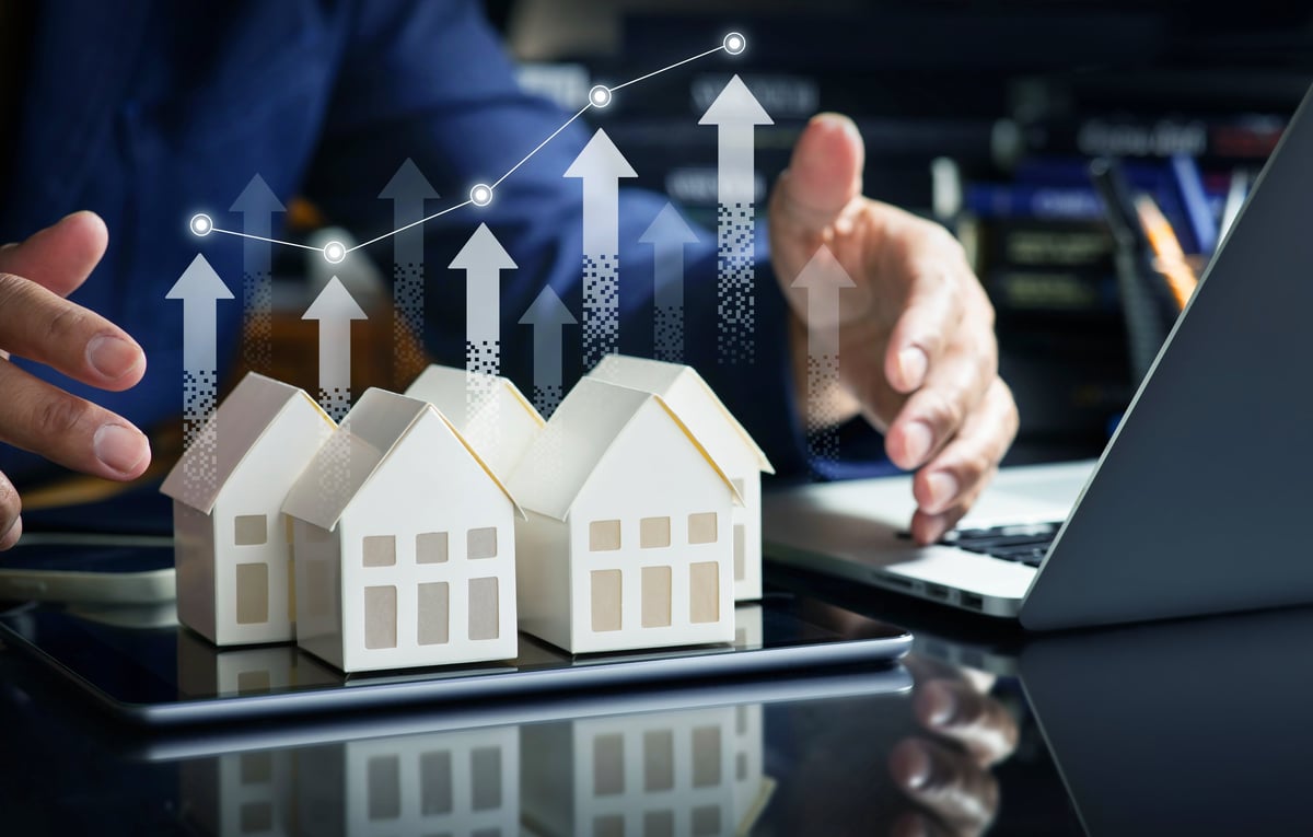 Investor reviewing rental property financing metrics and loan scenario with advisor