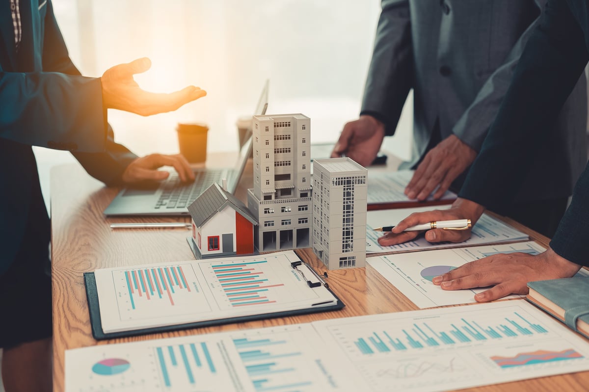 Investor reviewing rental property financing options and loan scenario with professional advisor