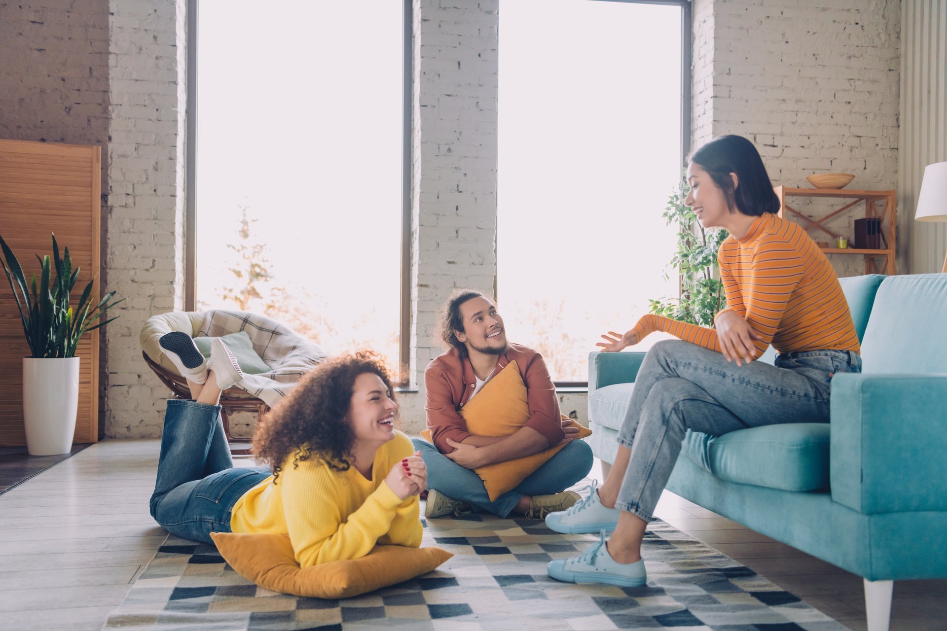 Group of college students relaxing together in a stylish shared living room