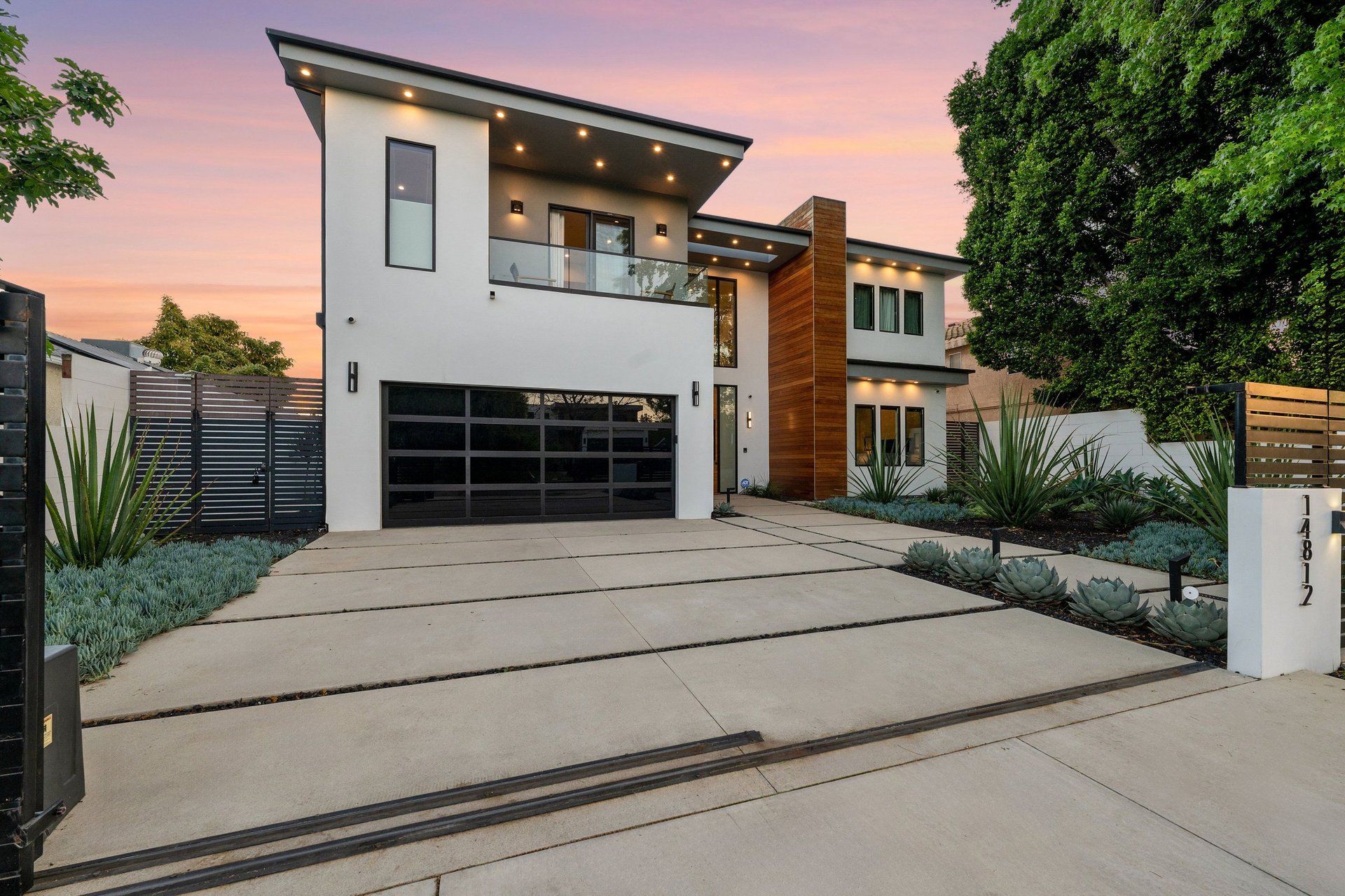 Twilight photo of a modern luxury home with pool and sleek architectural lines