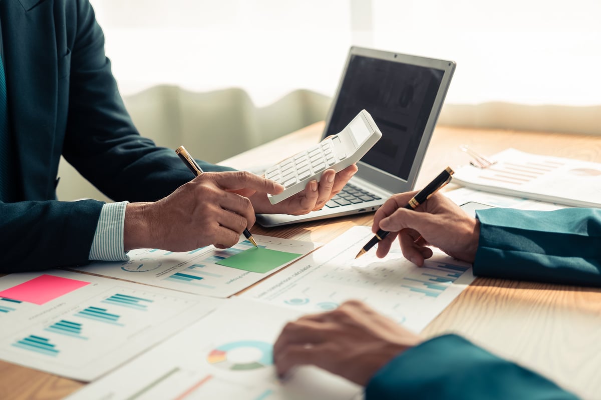 Business professionals analyzing DSCR loan financial reports for rental property investment