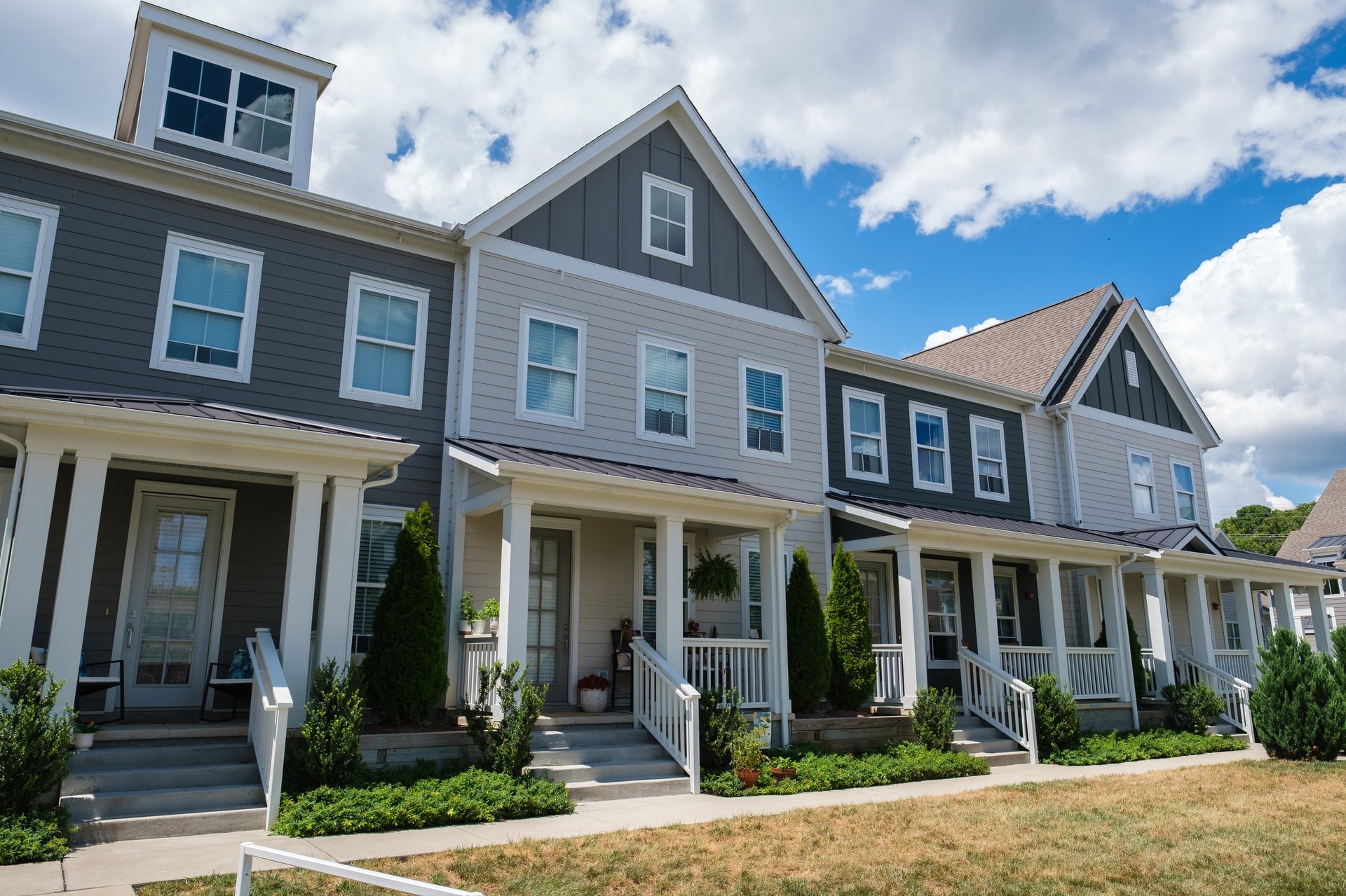 Modern wood-frame townhomes in a residential neighborhood near a college campus