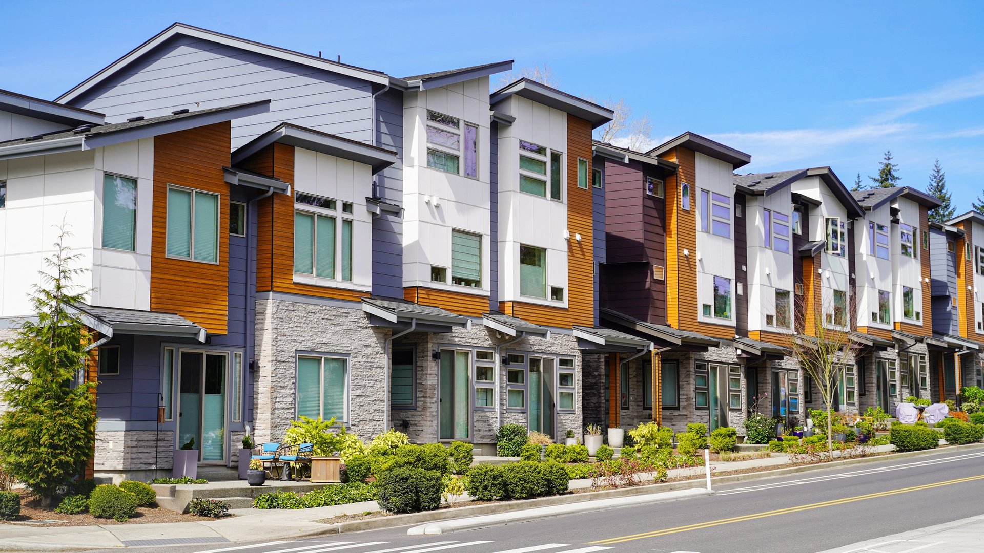 A row of modern townhomes with contemporary architecture and clean lines