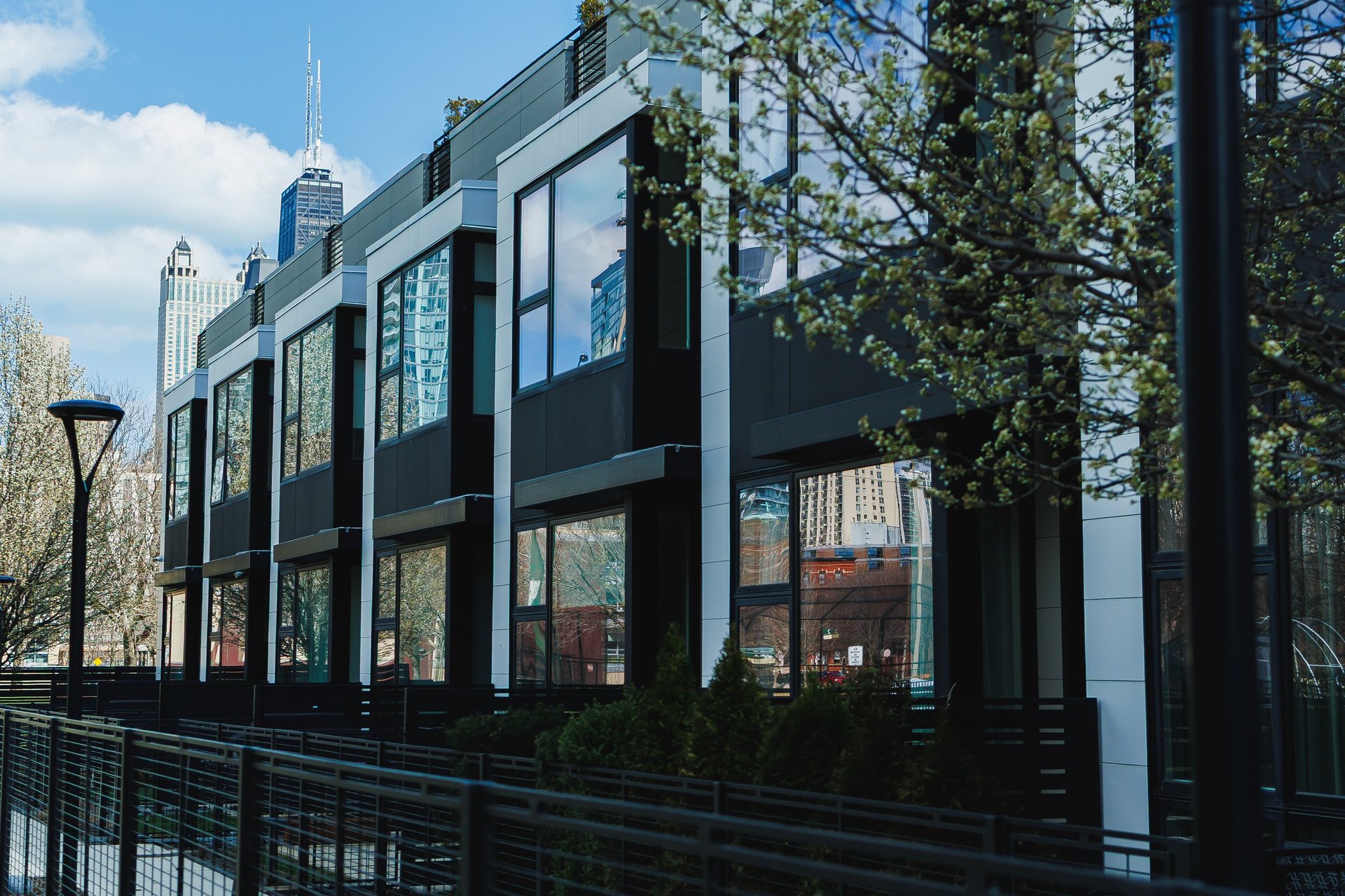 Modern condominium buildings with large glass windows in a vibrant college-town setting