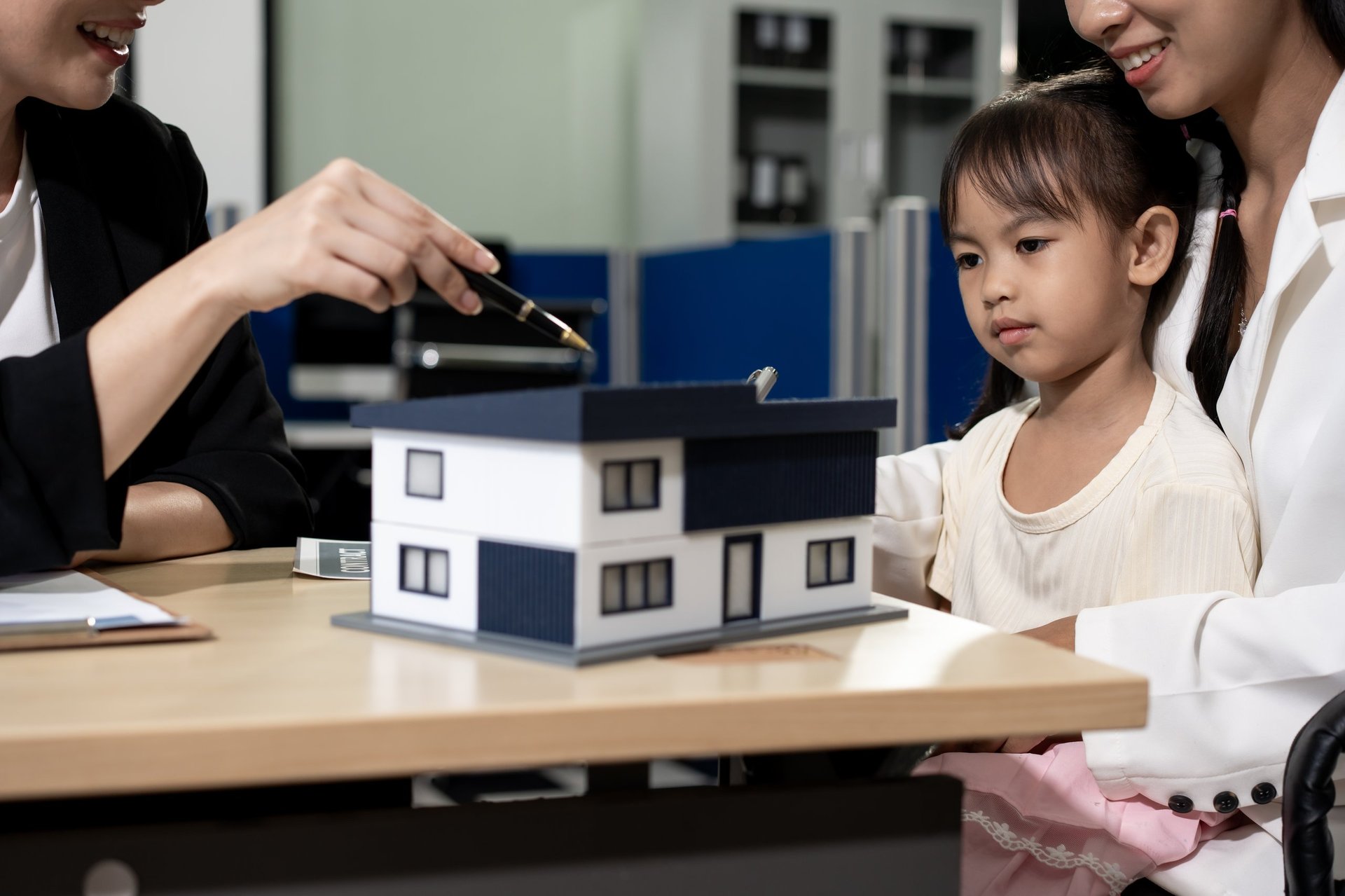 Parent and student reviewing a home model together during a home-buying decision